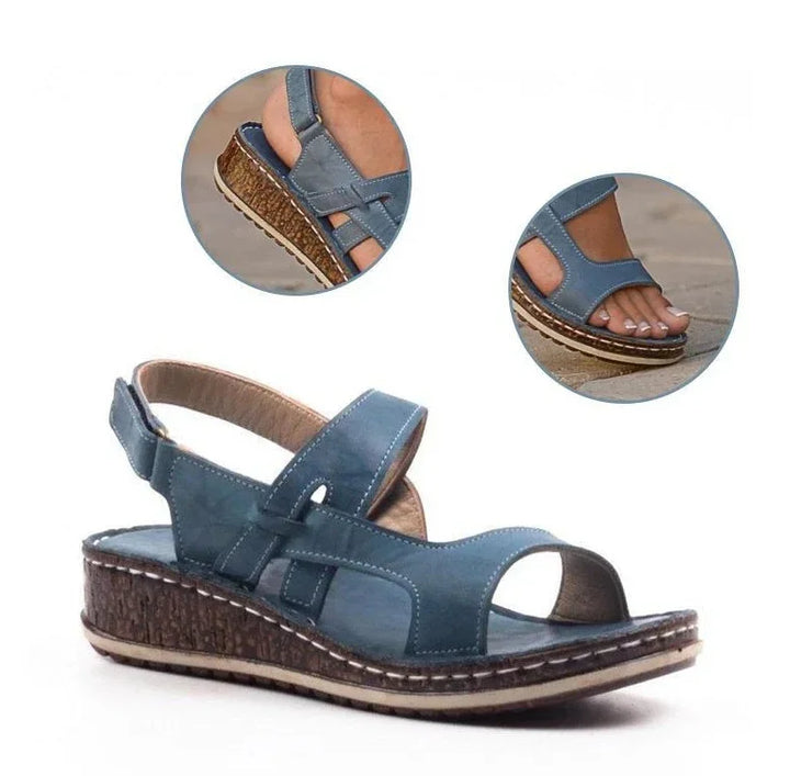 Blue leather women's wedge sandals with adjustable straps and cork-textured sole detail