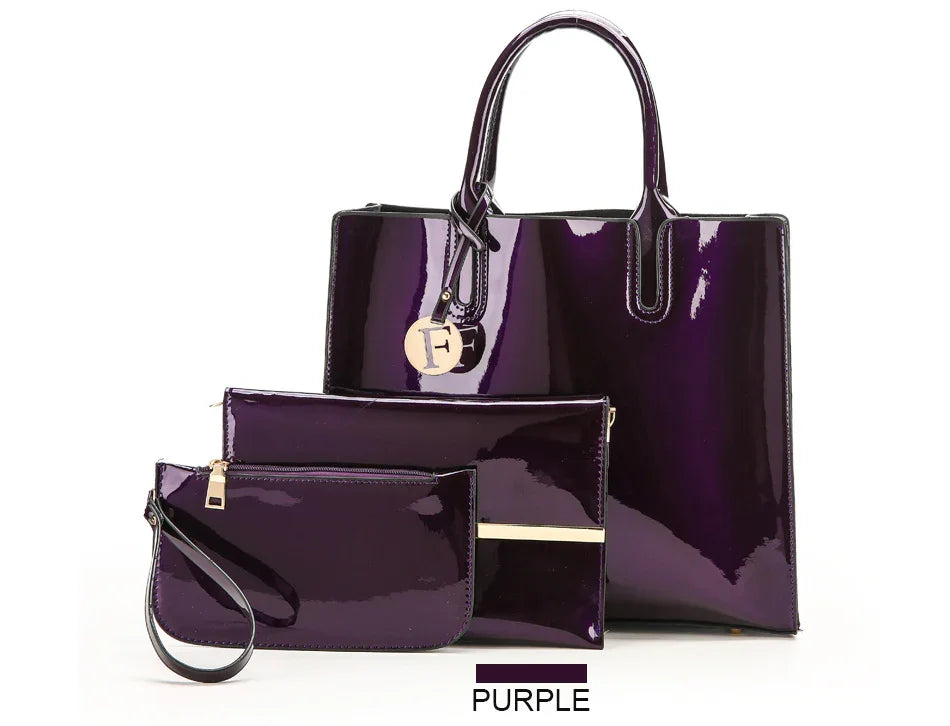 Glossy purple women's handbag set including tote bag, clutch, and wristlet on white background