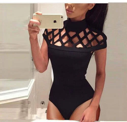 Woman taking mirror selfie in black bodysuit with lattice cutout design and high neckline