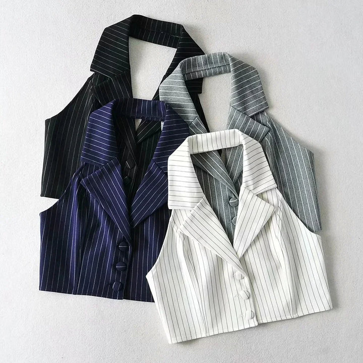 Four sleeveless pinstripe cropped blazers in black, navy, gray, and white with collars and buttons on a light background