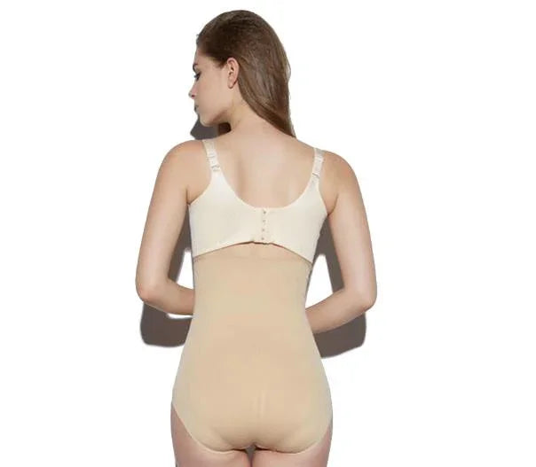 Back view of woman wearing beige high-waisted shapewear bodysuit and nude bra against white background