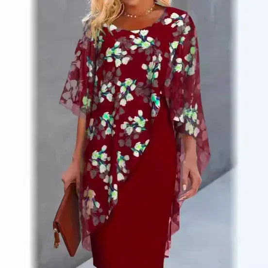 Woman wearing elegant red floral midi dress with sheer overlay and carrying brown clutch