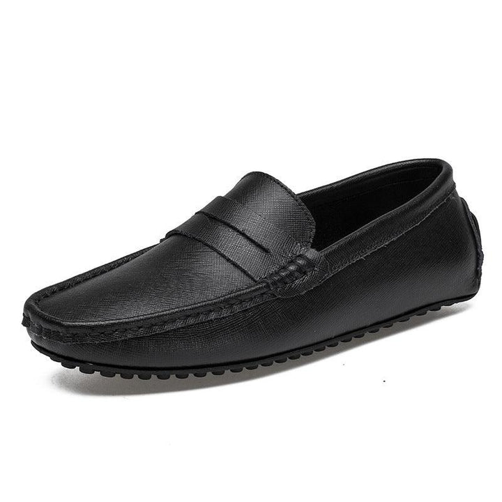 Black leather men's loafer with textured finish and rubber sole on white background