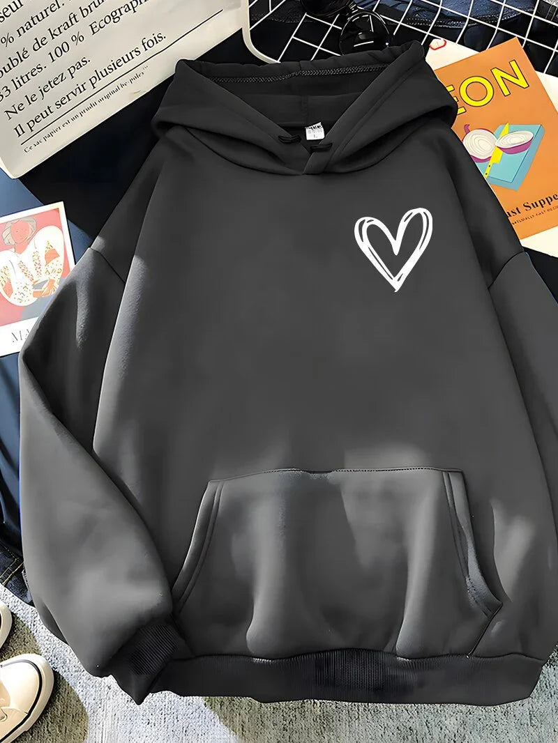 Black hoodie with white hand-drawn heart graphic on chest, displayed on casual background