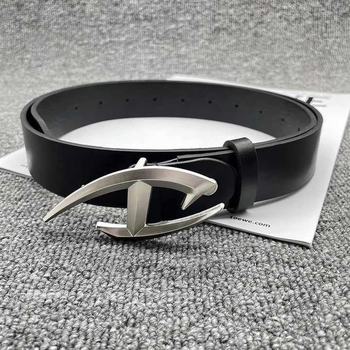 Black leather belt with distinctive silver metal buckle on gray textured surface