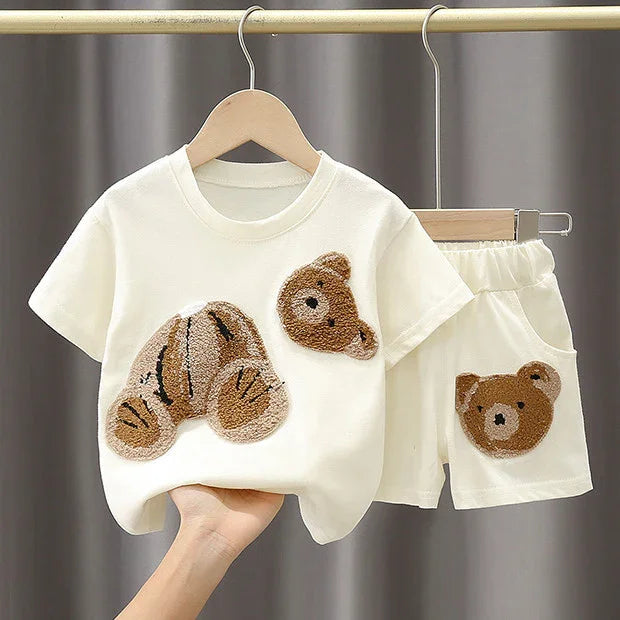 Cream toddler outfit with short-sleeve top and shorts, featuring textured bear appliques on front and pocket
