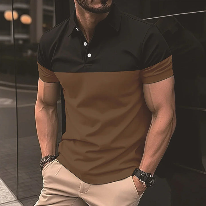 Man wearing a black and brown short-sleeve polo shirt with beige pants, black watch, and bracelets