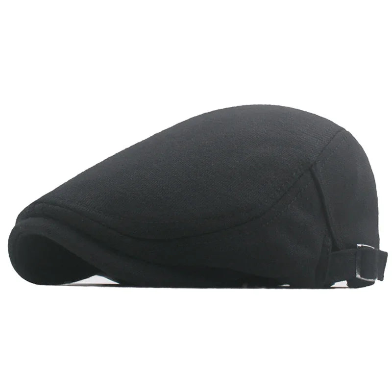 Classic black flat cap made of soft fabric with adjustable strap on white background