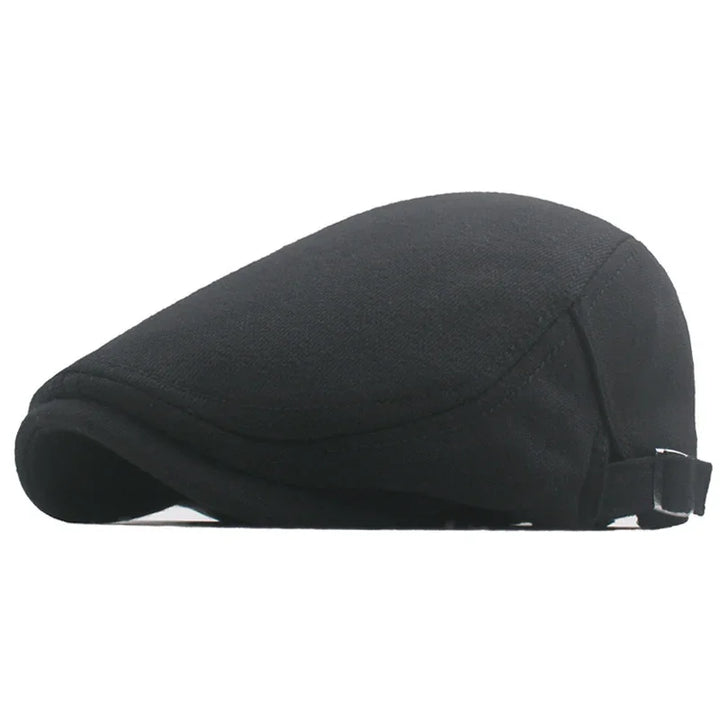 Classic black flat cap made of soft fabric with adjustable strap on white background