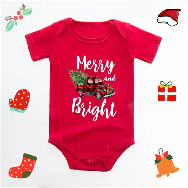 Red baby onesie with Christmas truck and tree design, text Merry and Bright, festive holiday icons