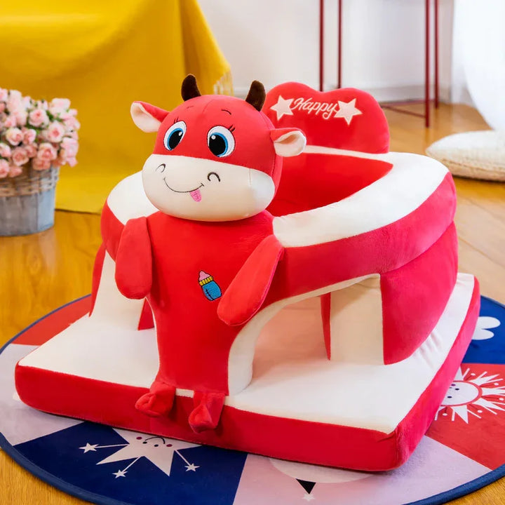 Red and white plush baby chair with a smiling cow design and 'Happy' text on backrest