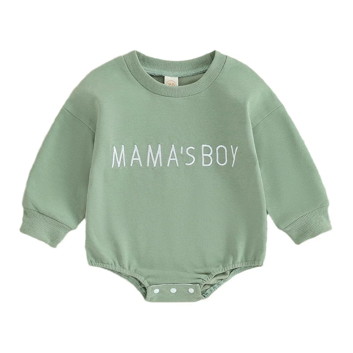 Green baby bodysuit with long sleeves and white text reading 'MAMA'S BOY', snap buttons at bottom