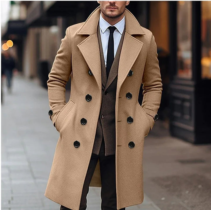 Man wearing a stylish camel double-breasted coat over suit and tie on city street