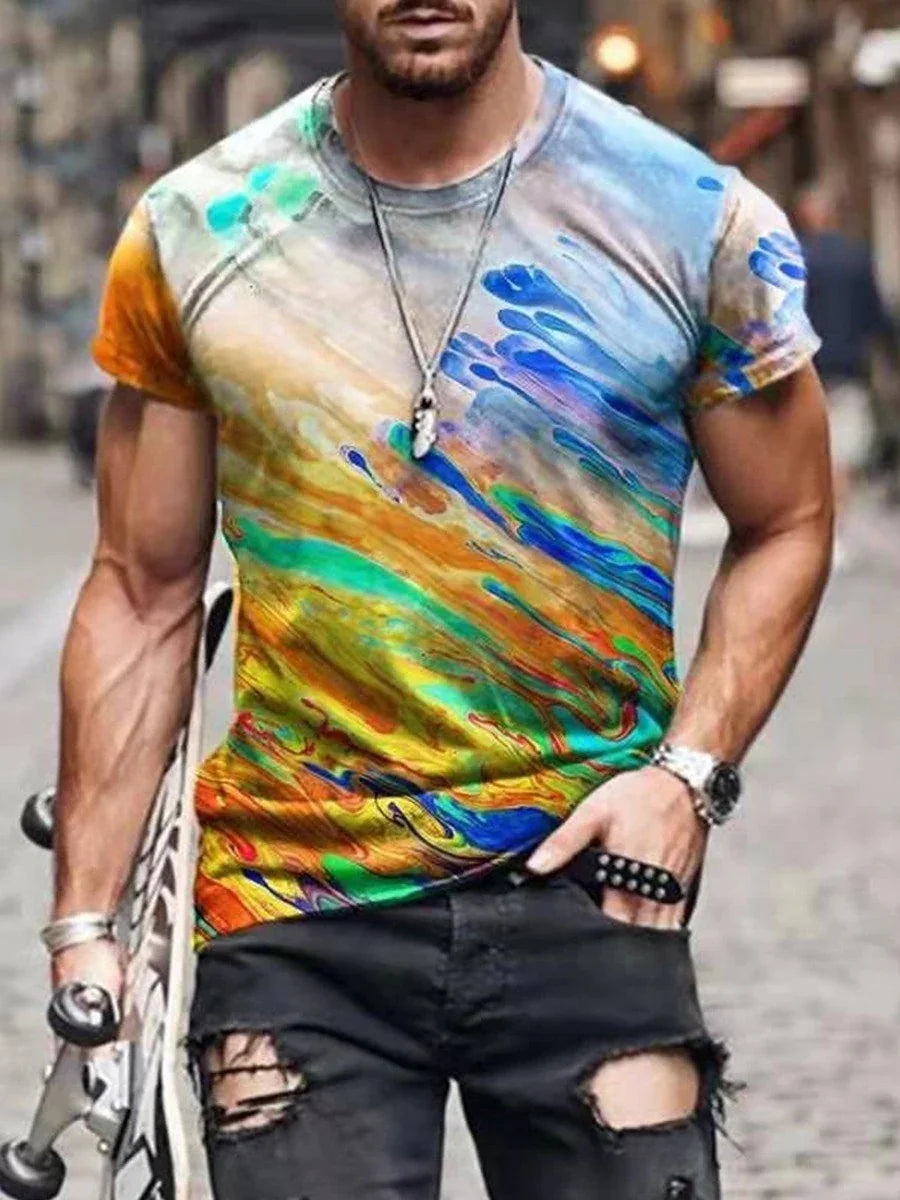 Man wearing colorful abstract print t-shirt with ripped black jeans holding a skateboard on a street