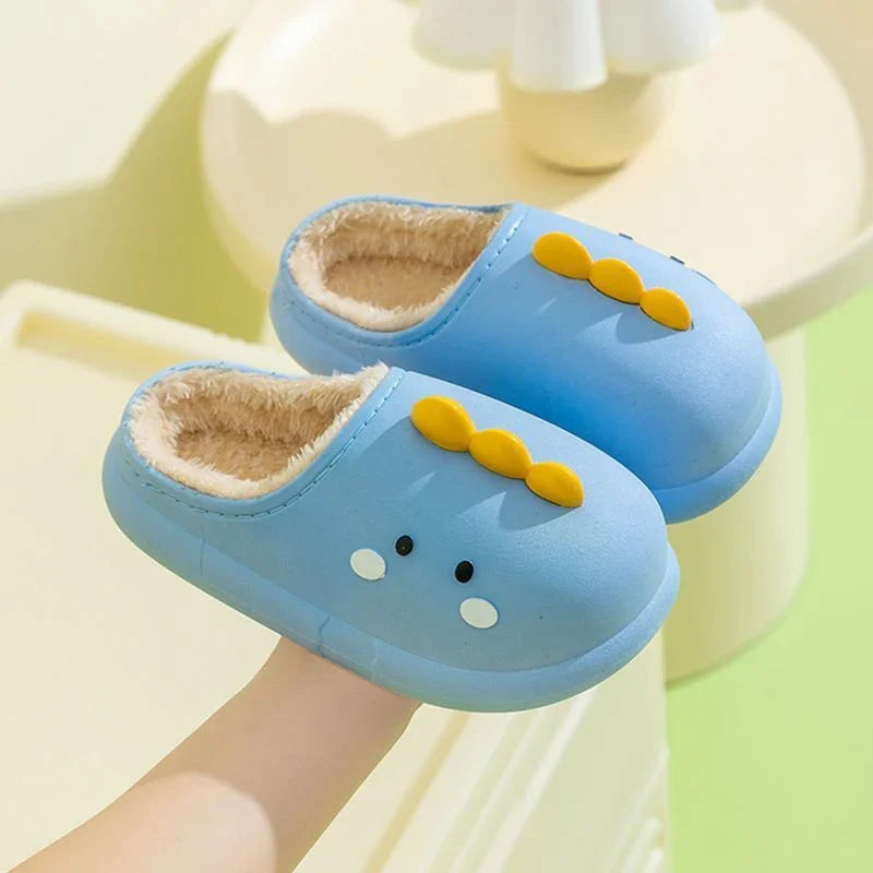 Child's blue winter slippers with yellow dinosaur spikes and soft beige lining