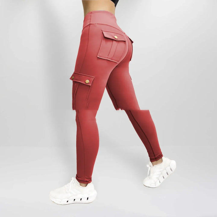 Woman wearing high-waisted red cargo leggings with flap pockets and white sneakers