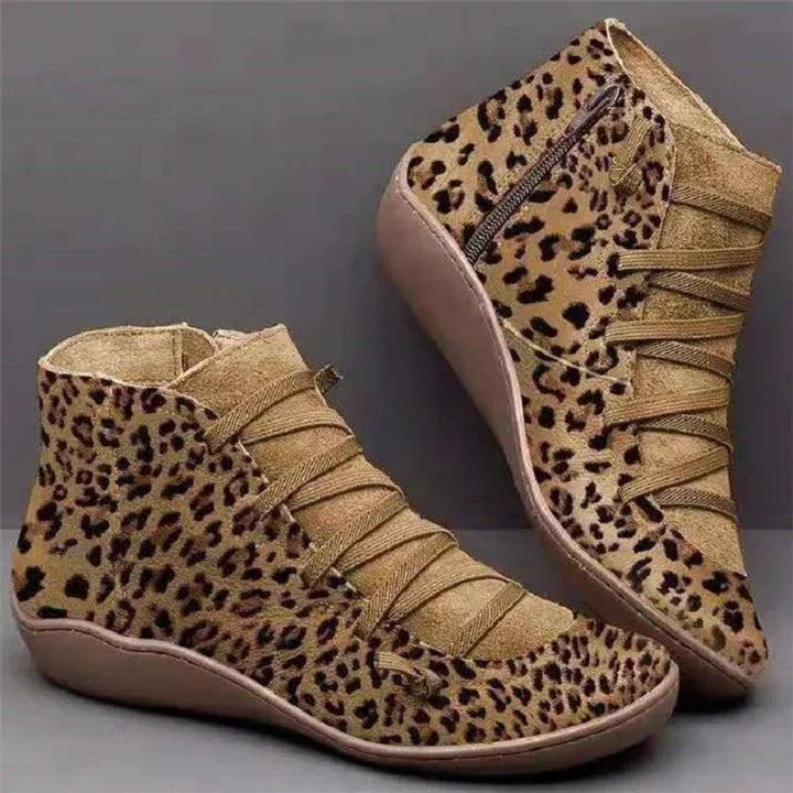 Leopard print wedge ankle boots with lace-up design and side zipper on gray background