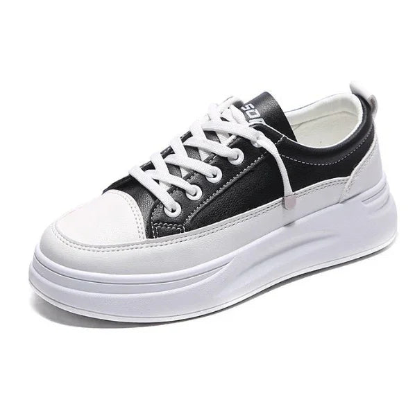 Black and white casual platform sneaker with white laces and thick sole isolated on white