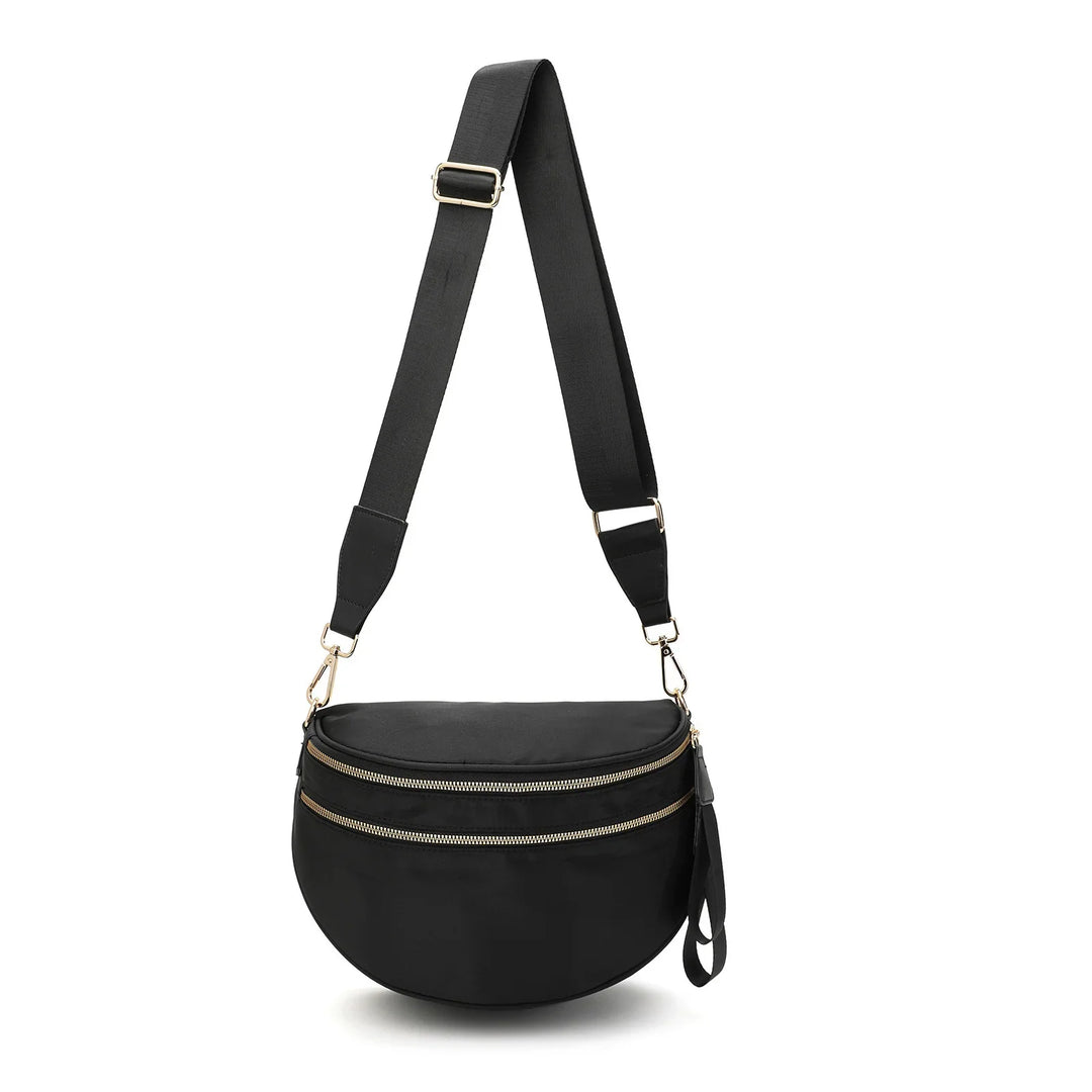 Black crescent crossbody bag with dual gold zippers and adjustable wide strap