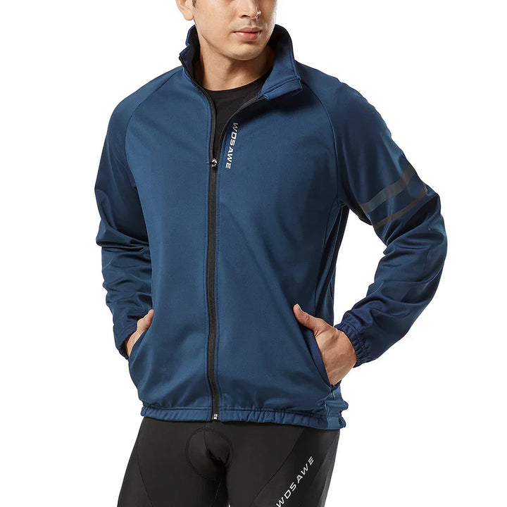Man in blue cycling jacket with zipper and reflective stripes, hands in pockets, white background