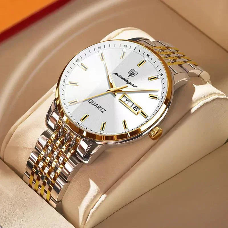 gold and silver quartz wristwatch with white dial and date display on beige cushion