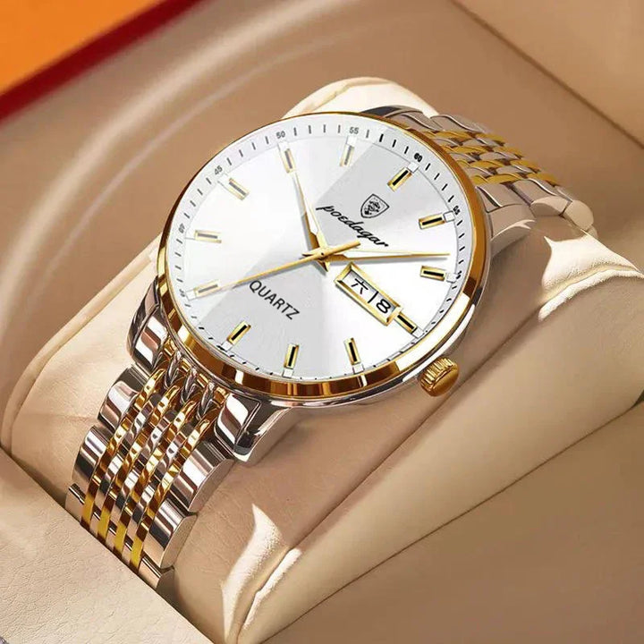 gold and silver quartz wristwatch with white dial and date display on beige cushion