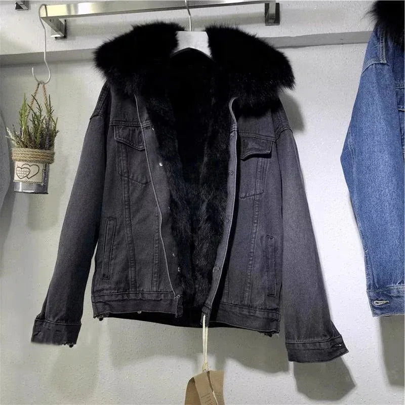 Black denim jacket with thick black fur lining and collar hanging on wall hook