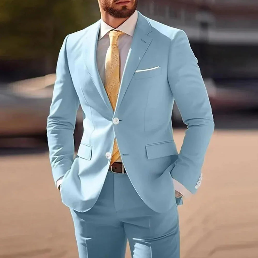 Man in tailored light blue suit with white shirt and yellow patterned tie outdoors