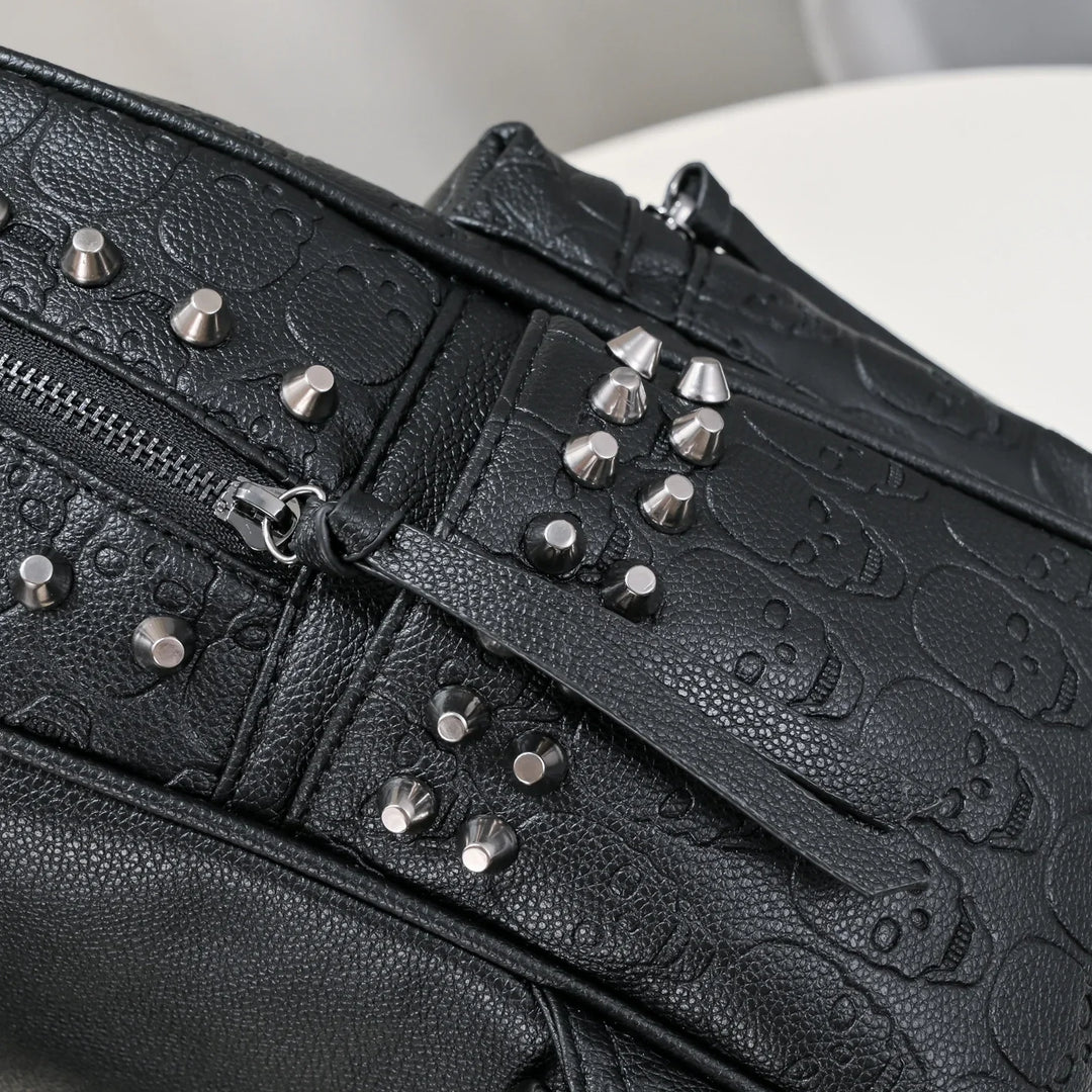 Black leather bag with embossed skull pattern and silver metal studs detail
