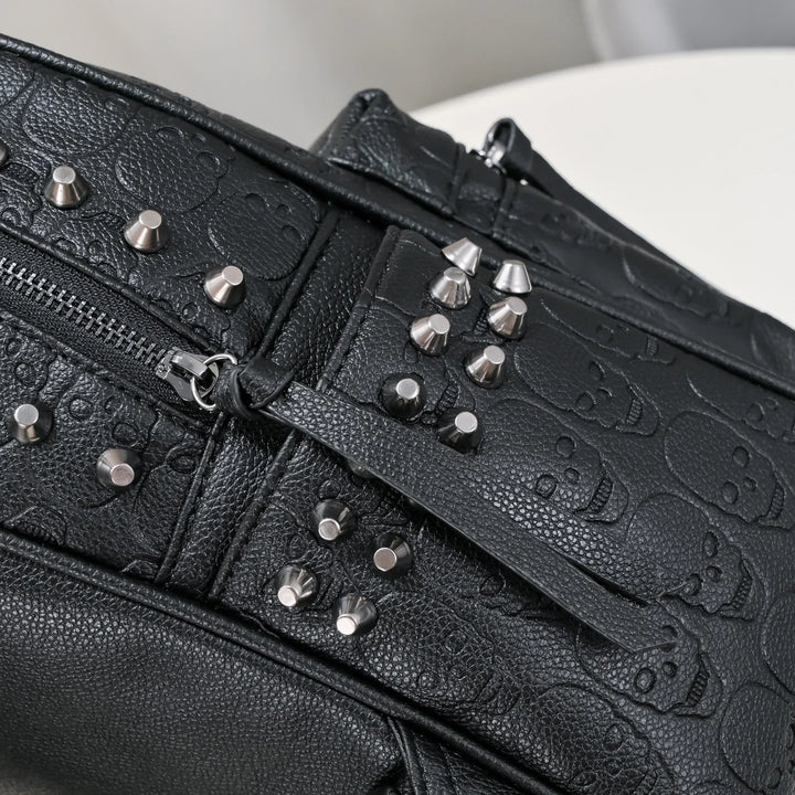 Black leather bag with embossed skull pattern and silver metal studs detail