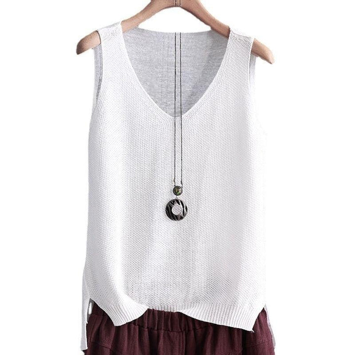 White knitted sleeveless top with V-neck on wooden hanger, paired with maroon pants and layered pendant necklace
