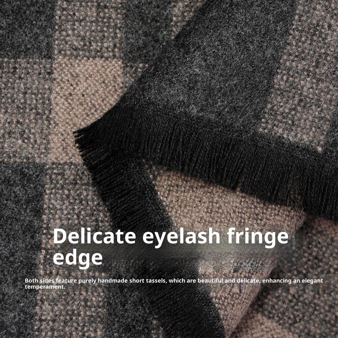 Close-up of a gray and black checkered wool scarf with delicate handmade fringe tassels