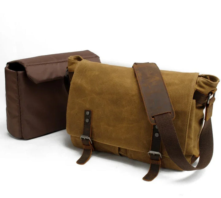 Brown canvas messenger bag with leather straps and shoulder pad, next to a dark brown pouch