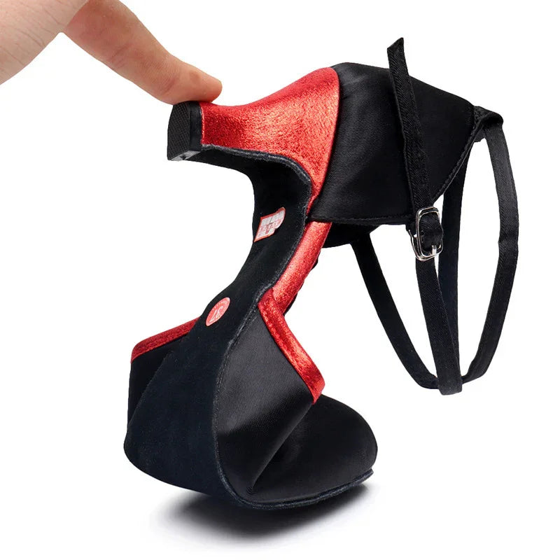 Flexible black and red high heel shoe demonstrating bendable sole with adjustable ankle strap