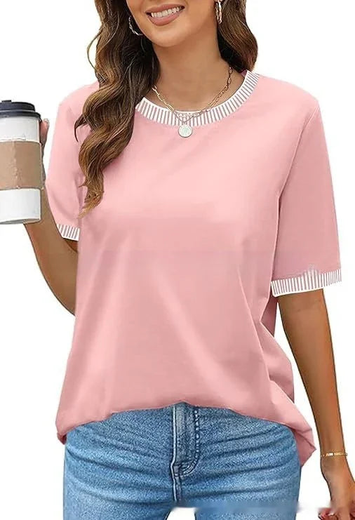 Woman wearing pink short-sleeve casual top with striped neckline and sleeve cuffs, holding coffee cup