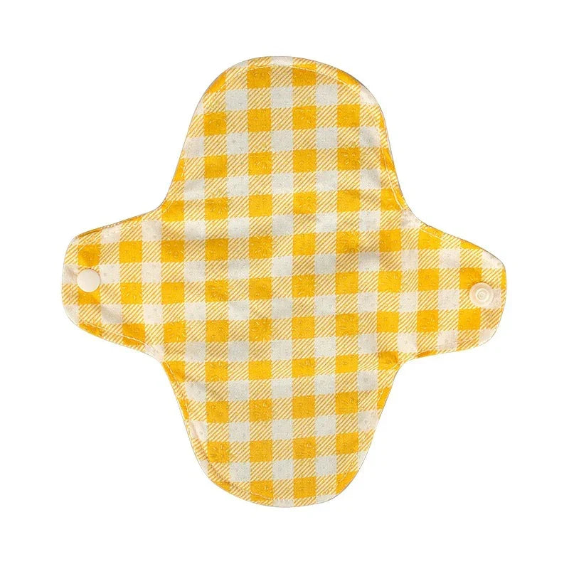 Yellow and white checkered reusable cloth pad with snap buttons on wings