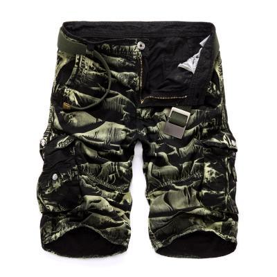 Men's green camouflage cargo shorts with multiple pockets and a partially unzipped fly