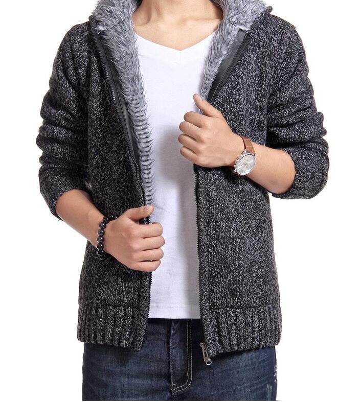 Man wearing gray knit zip-up cardigan with faux fur hood and white t-shirt