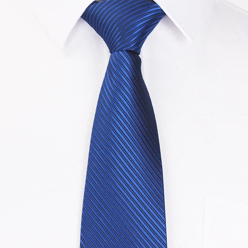 Close-up of blue striped silk tie on white dress shirt with classic collar