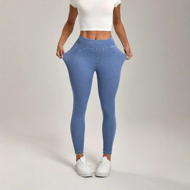 Woman wearing stretchy blue jeggings and white crop top showcasing flexible slim-fit leggings