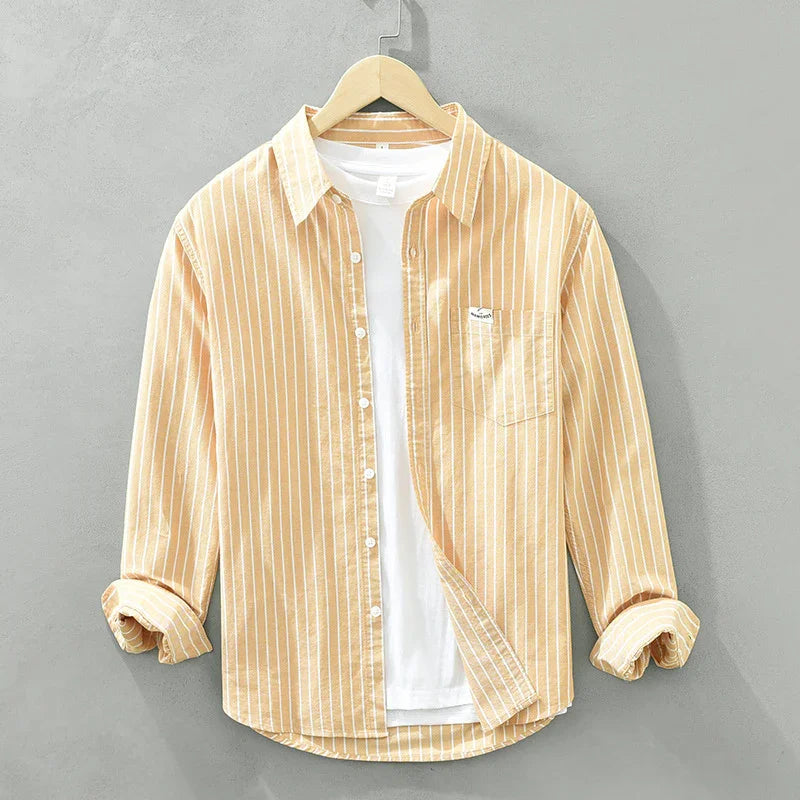 Yellow striped casual button-up shirt layered over a white t-shirt on a wooden hanger