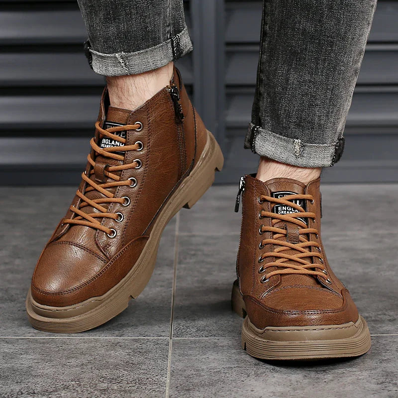 Pair of brown leather casual boots with side zipper and lace-up design worn with rolled grey jeans
