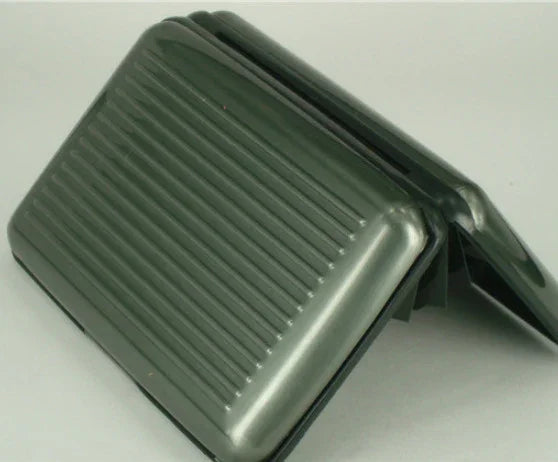 Black plastic foot pedal with ribbed surface for grip on neutral background
