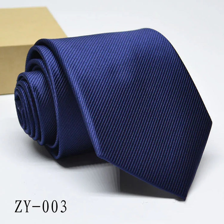 Rolled navy blue silk necktie with subtle diagonal stripes on white background, model ZY-003