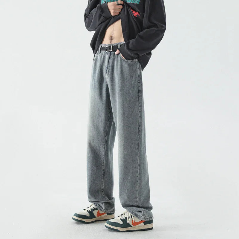 Casual outfit featuring loose-fit gray jeans, black belt, black sweatshirt, and white sneakers with orange swoosh