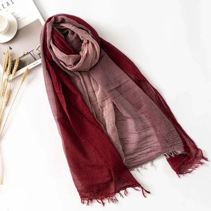 Soft gradient scarf in burgundy and dusty pink with fringed edges on white background