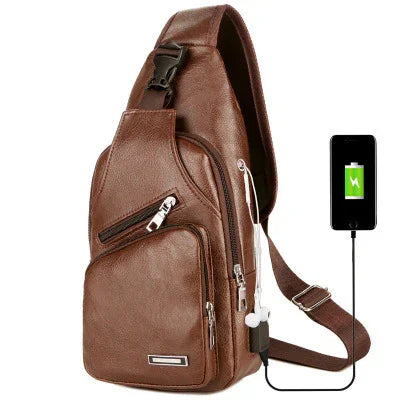 Brown leather sling backpack with multiple zippered pockets and USB charging port connected to a smartphone