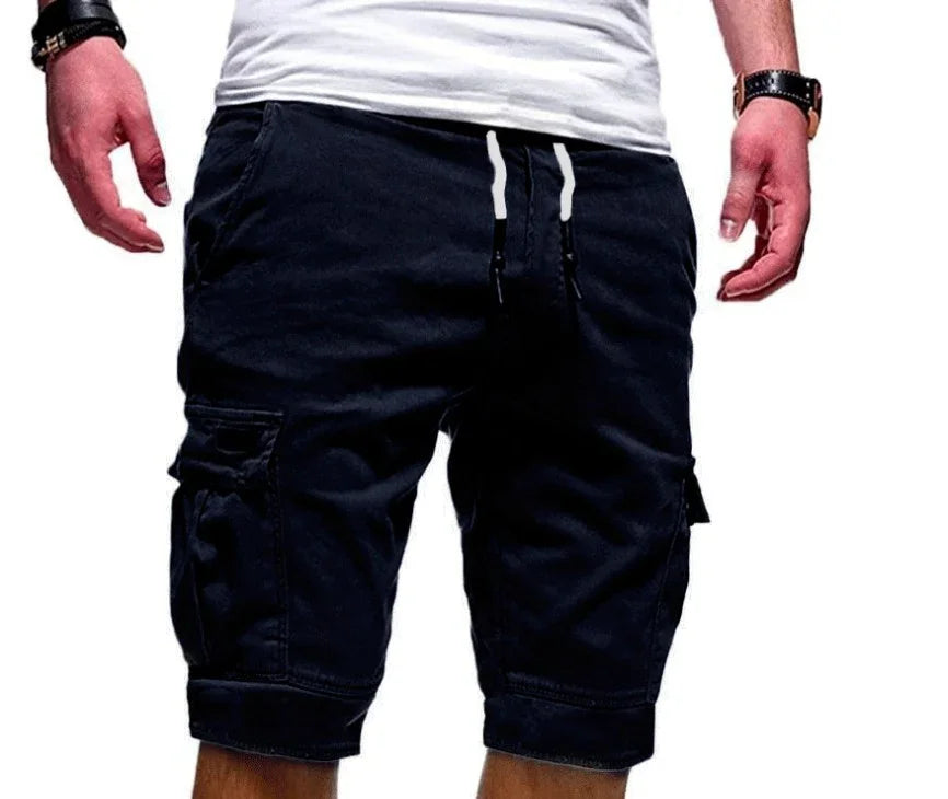 Man wearing black cargo shorts and white t-shirt with wristwatch on white background