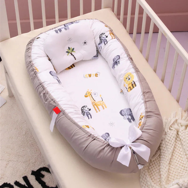 Baby nest with gray edges and animal prints including giraffe, lion, elephant inside white crib