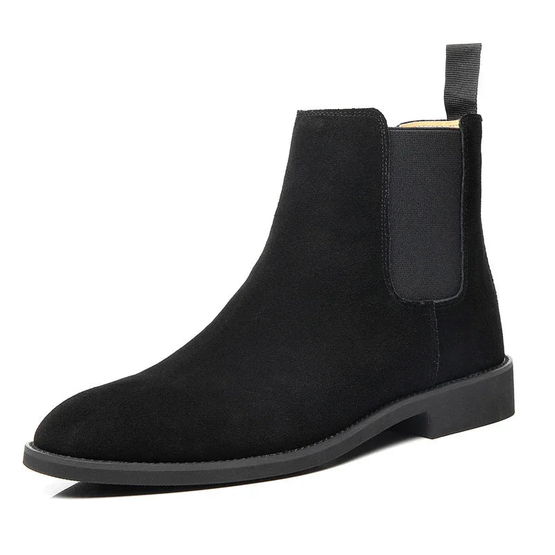 Black suede Chelsea boot with elastic side panel and pull tab on white background